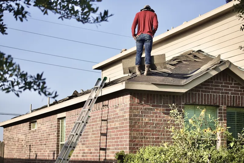 Professional roofer working on a residential roof in Krugerville